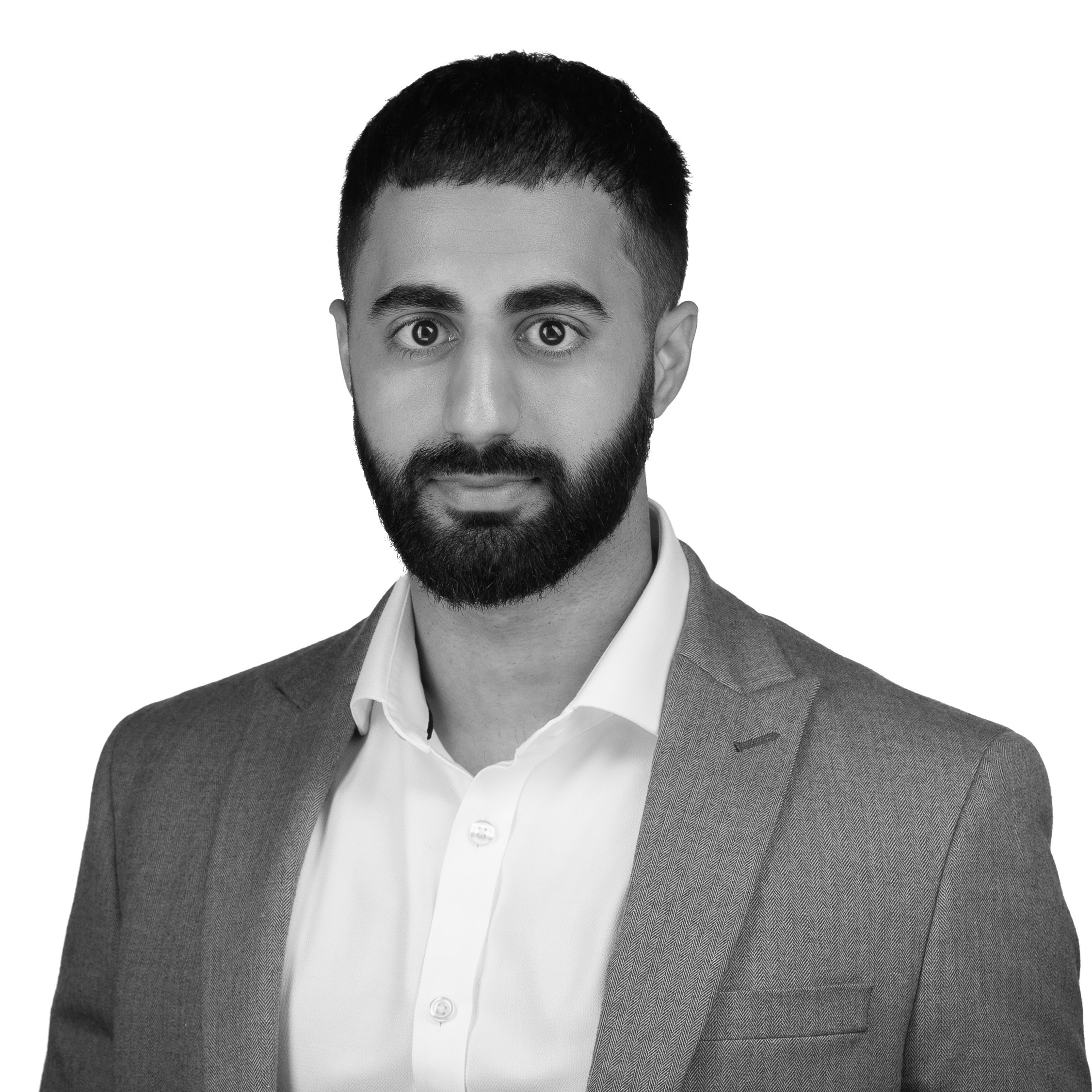 A black and white headshot image of a smiling man against a white backdrop